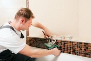 one of our plumbers in Alexandria, VA is repairing a bathroom leak