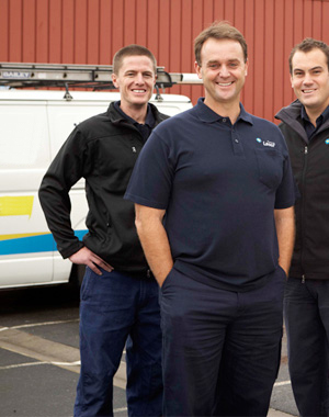 three of our Alexandria VA plumbing contractors standing ready by their truck